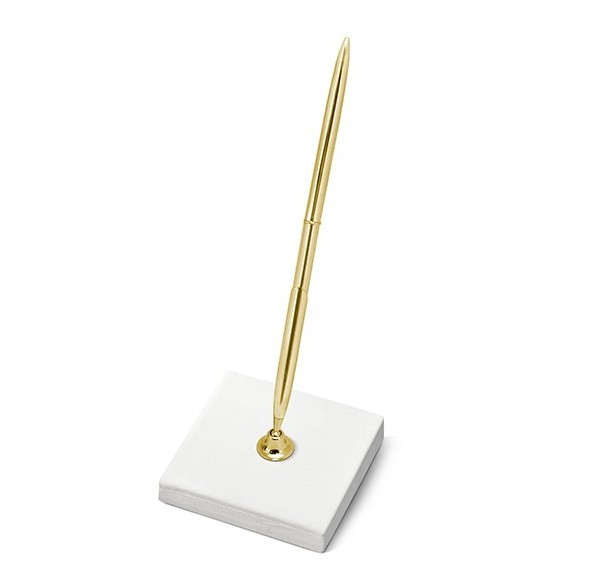 Cream colored pen holder with gold pen