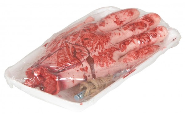 Severed hand bloody in refrigerated shelf packaging