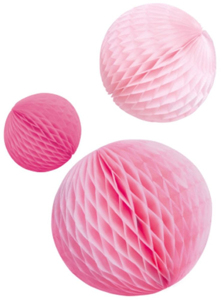 3 różowe kulki o strukturze plastra miodu